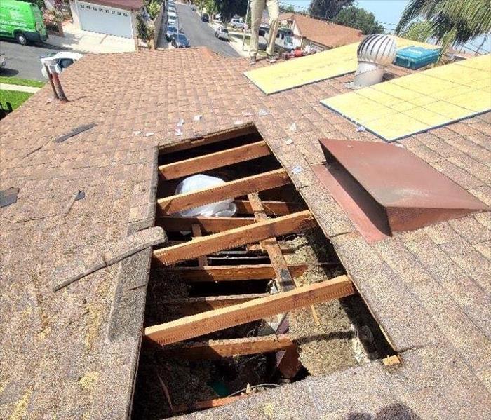 Hole cut open on the roof of a house because of a fire.
