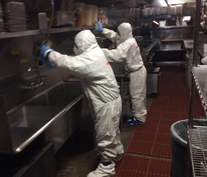 SERVPRO employee's disinfecting a kitchen at a restaurant 